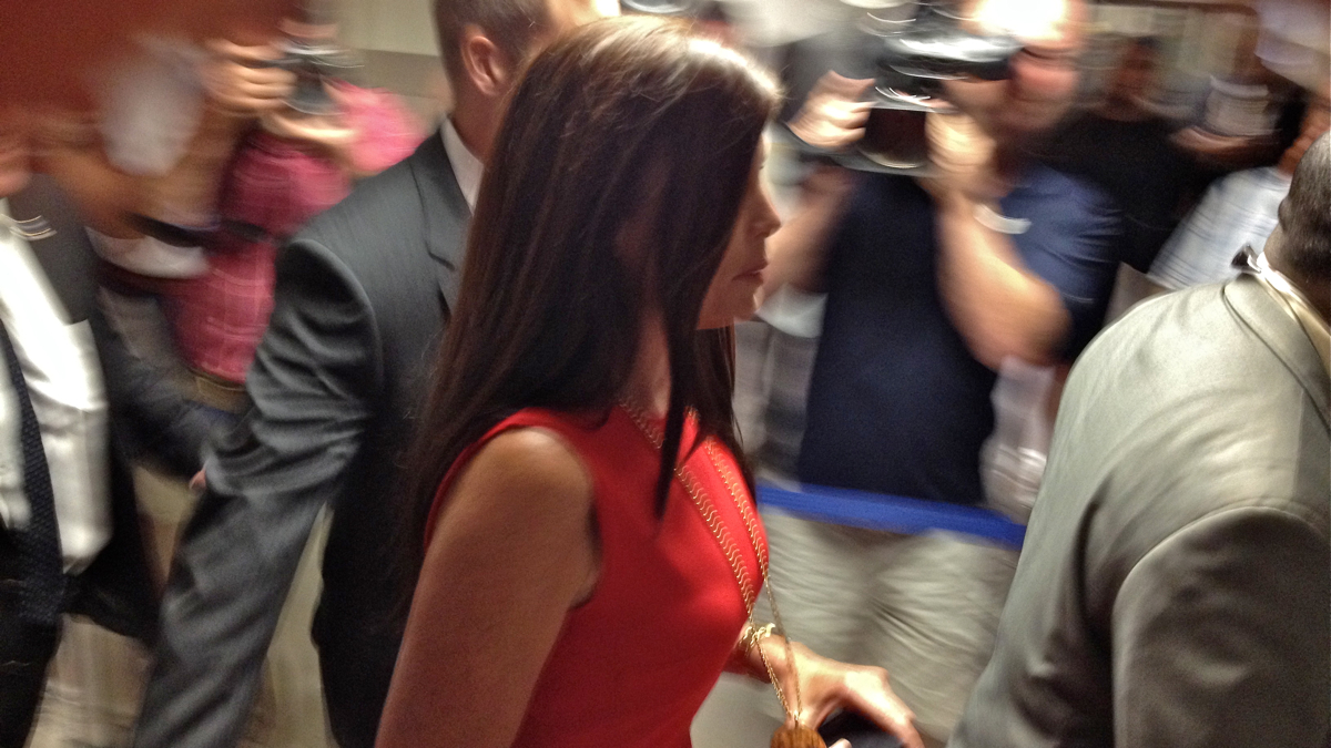  Pennsylvania Attorney General Kathleen Kane rushes through a media gauntlet on her way to court in Norristown, where she was ordered to stand trial on charges of leaking grand jury material. (Dave Davies/WHYY) 