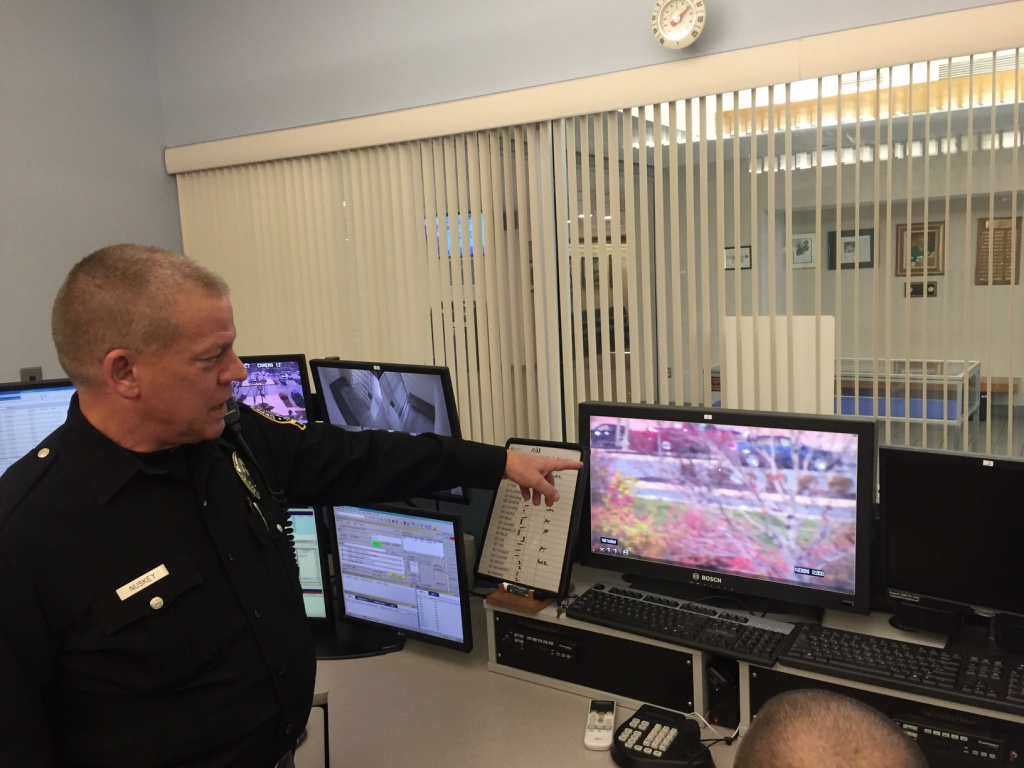 Officer Harry Nuskey of the Upper Merion Police Department points to monitors used to keep an eye on parking lot outside the King of Prussia Mall (Rob Zawatski for NewsWorks)