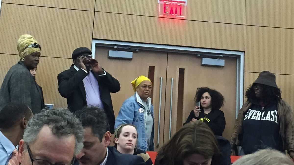  Pam Africa, center, interrupts a Philadelphia mayoral forum to chastise Lynne Abraham for signing arrest warrants for MOVE members in 1985. (Eric Walter/NewsWorks)  