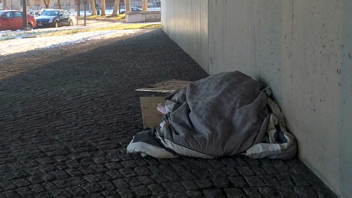 Taking shelter under the I-676 overpass. (Emma Lee/WHYY)