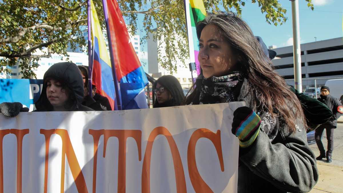 Jasmine Rivera, right, of the Latino community advocacy group Juntos says changing Philadelphia's policy to be more cooperative with the federal Immigration and Customs Enforcement agency means more deportations. (NewsWorks file photo) 