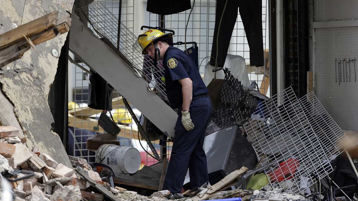 A firefighter walks through the aftermath of a building that collapsed in Center City