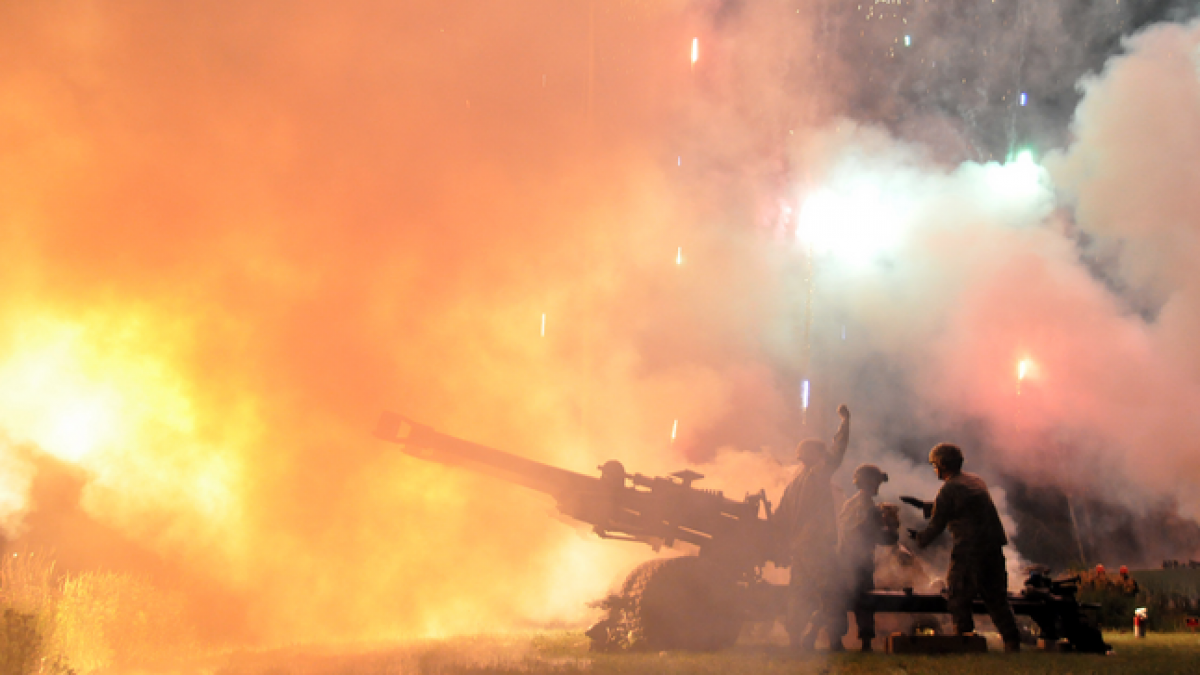 oldiers from the Wisconsin Army National Guard's 1st Battalion, 120th Field Artillery fire powder charges from a M119A2 towed 105-mm howitzer on July 2, 2011. (Wisconsin National Guard photo by 1st Sgt. Vaughn R. Larson) 