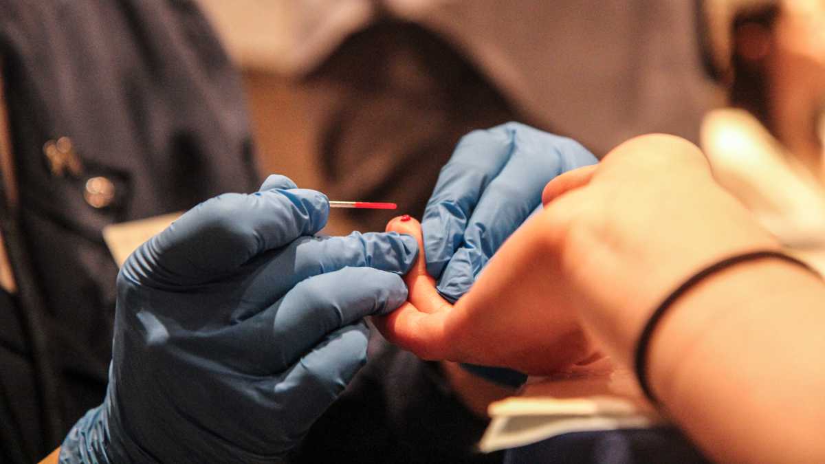 Blood is drawn for lead testing at a health fair in a county affected by Hurricane Sandy. (Kimberly Paynter/WHYY)