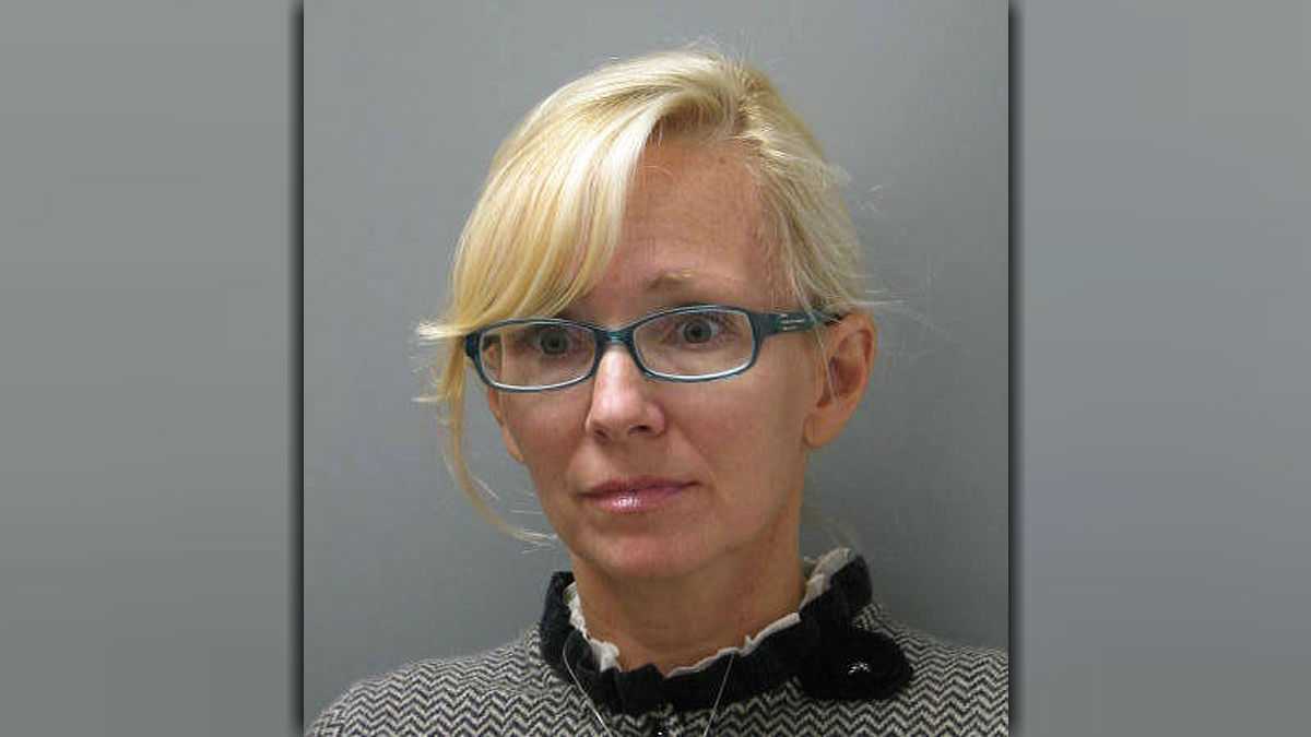  In this undated photo provided Wednesday, Nov. 5, 2014 by the Delaware State Police, Molly Shattuck, of Baltimore, poses for a police mug shot. Shattuck, 47, a former Baltimore Ravens cheerleader and the estranged wife of a prominent Maryland energy executive has been arrested and charged in connection with a sexual relationship involving a 15-year-old boy. Shattuck was indicted Monday, Nov. 3, 2014, on two counts of third-degree rape, four counts of unlawful sexual contact and three counts of providing alcohol to minors. (AP Photo/Delaware State Police) 