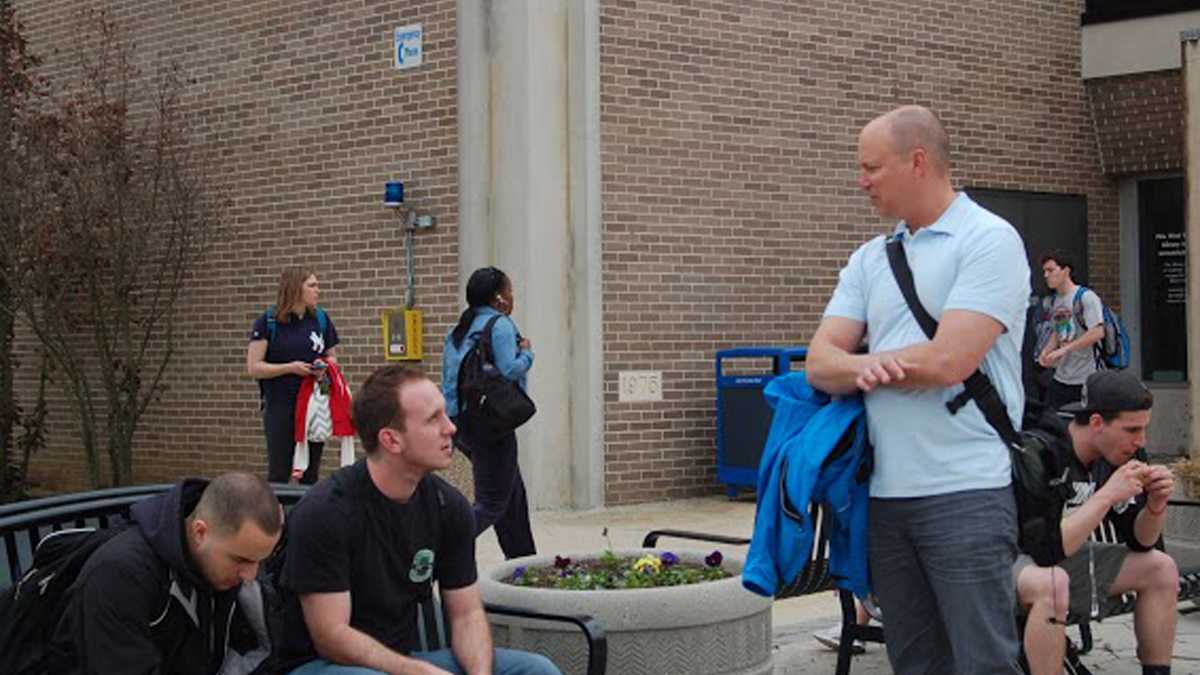  Students sit outside at West Chester University (Sara Hoover/WHYY)  
