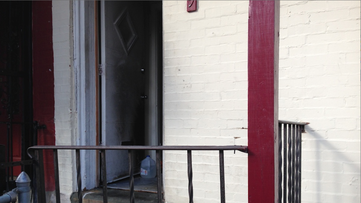  This Germantown front porch was where one of the firebombings took place over a five-week span in 2014 on East Coulter St. (Brian Hickey/WHYY) 