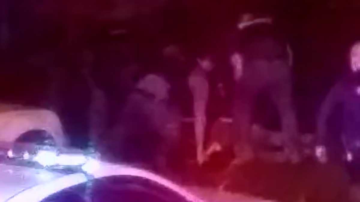 A screenshot from a phone video show police gathered around Tyree Carroll. (Courtesy of Tyree Carroll Family)