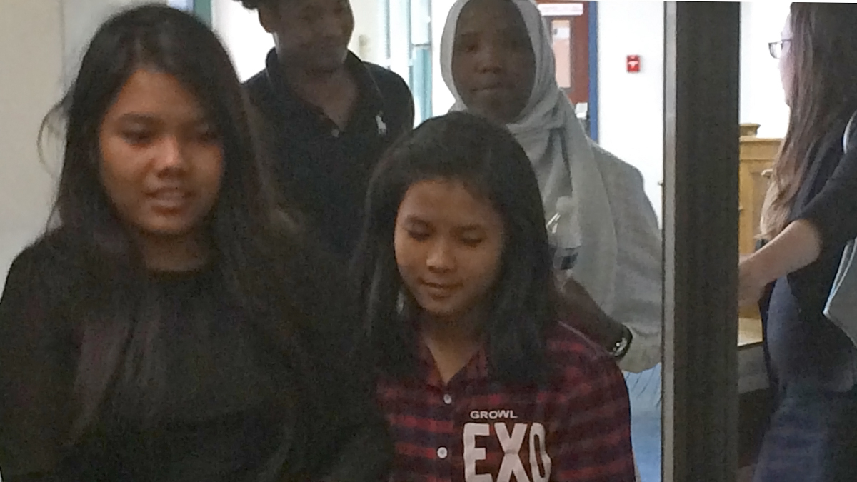 Sui Hnem Sung (left foreground), 19, and her sister Van Ni Iang, 17, leave federal court in Easton ahead of Qasin Hassan, 17,(left) and Khadidja Issa, 18. They’re among six student refugees represented by a legal team including Education Law Center and American Civil Liberties Union attorneys in a lawsuit against the School District of Lancaster over enrollment, translation and other issues. (Emily Previti/WITF)