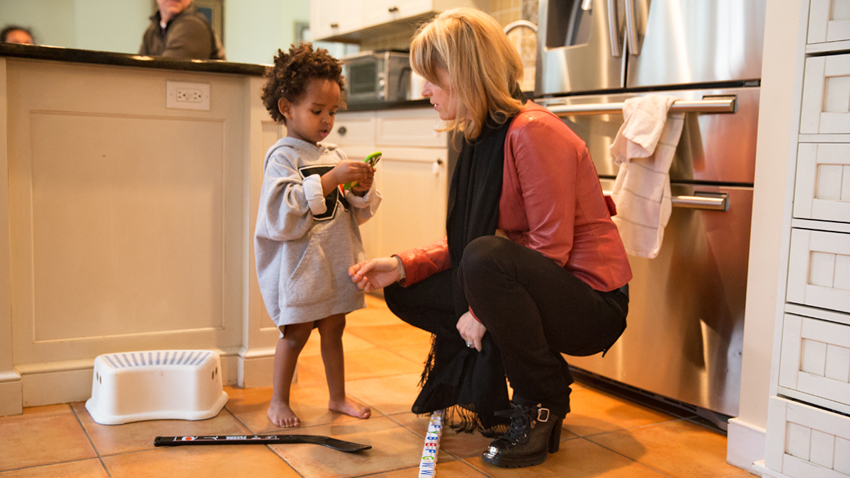  Lauren Hart helps her son Bek, 3, before heading off to sing the national anthem at a Philadelphia Flyers game.  (Lindsay Lazarski/WHYY) 