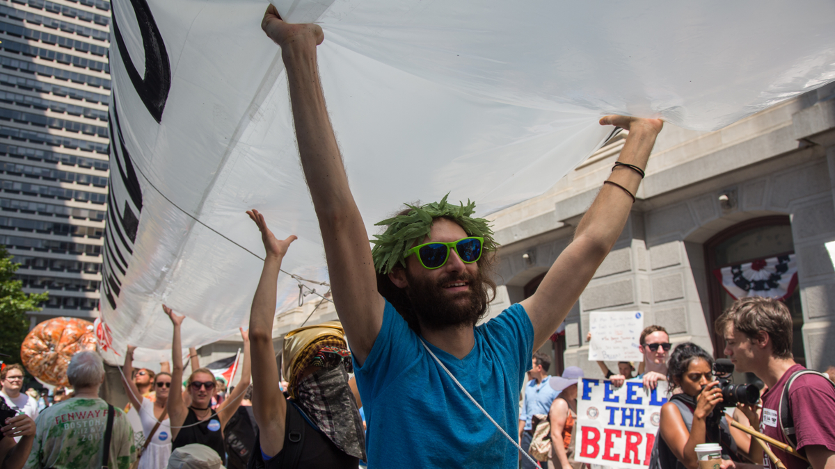 At least 20 people are needed to hold up each of the three 51-foot inflatable joints at the JayWalk, a march in support of the legalization of marijuana. The marchers were joined by others on their way to the Democratic National Convention at the Wells Fargo Center in Philadelphia July 25, 2016.  (Emily Cohen for NewsWorks)