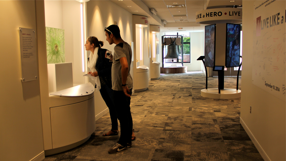  Visitors study the exhibits at the National Liberty Museum's new Welcome Gallery. (Emma Lee/WHYY) 