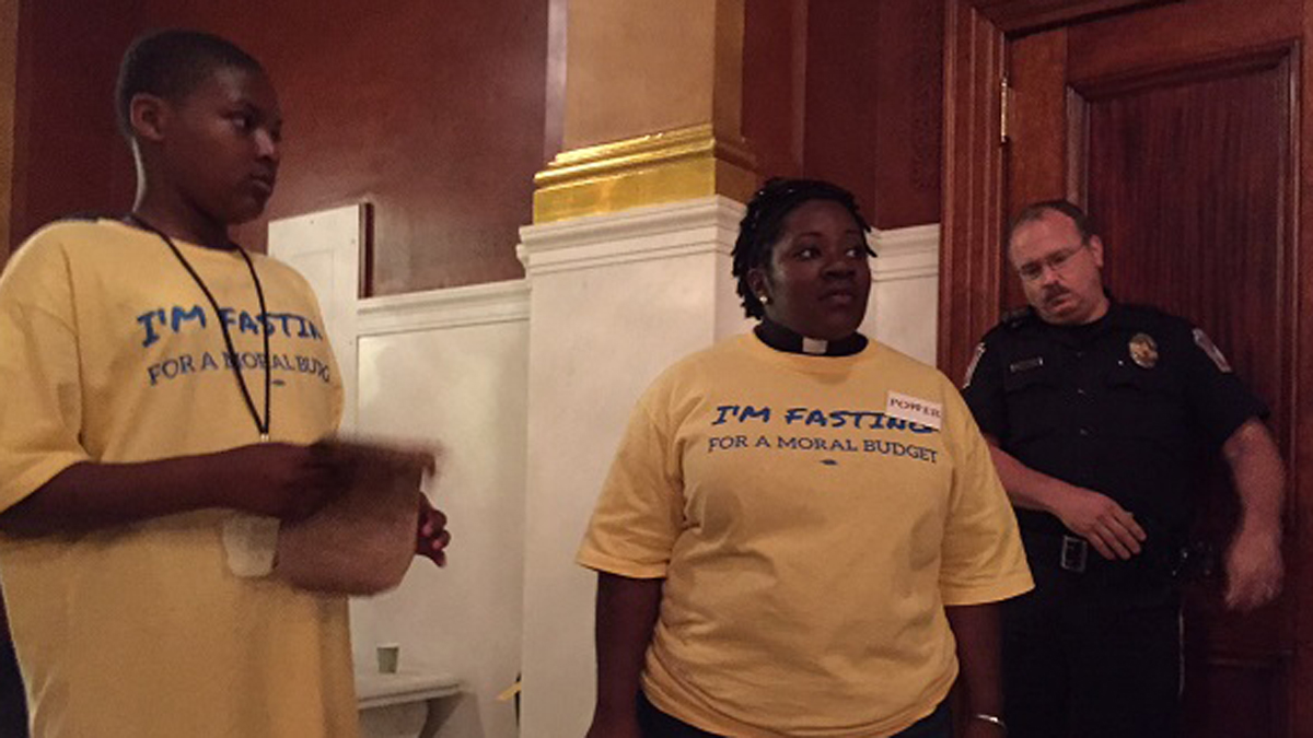  The Rev. Naomi Leapheart is among protesters congregating outside Gov. Tom Wolf's Harrisburg office to press their case for a funding formula that applies to all state spending for schools. (Mary Wilson/WHYY) 