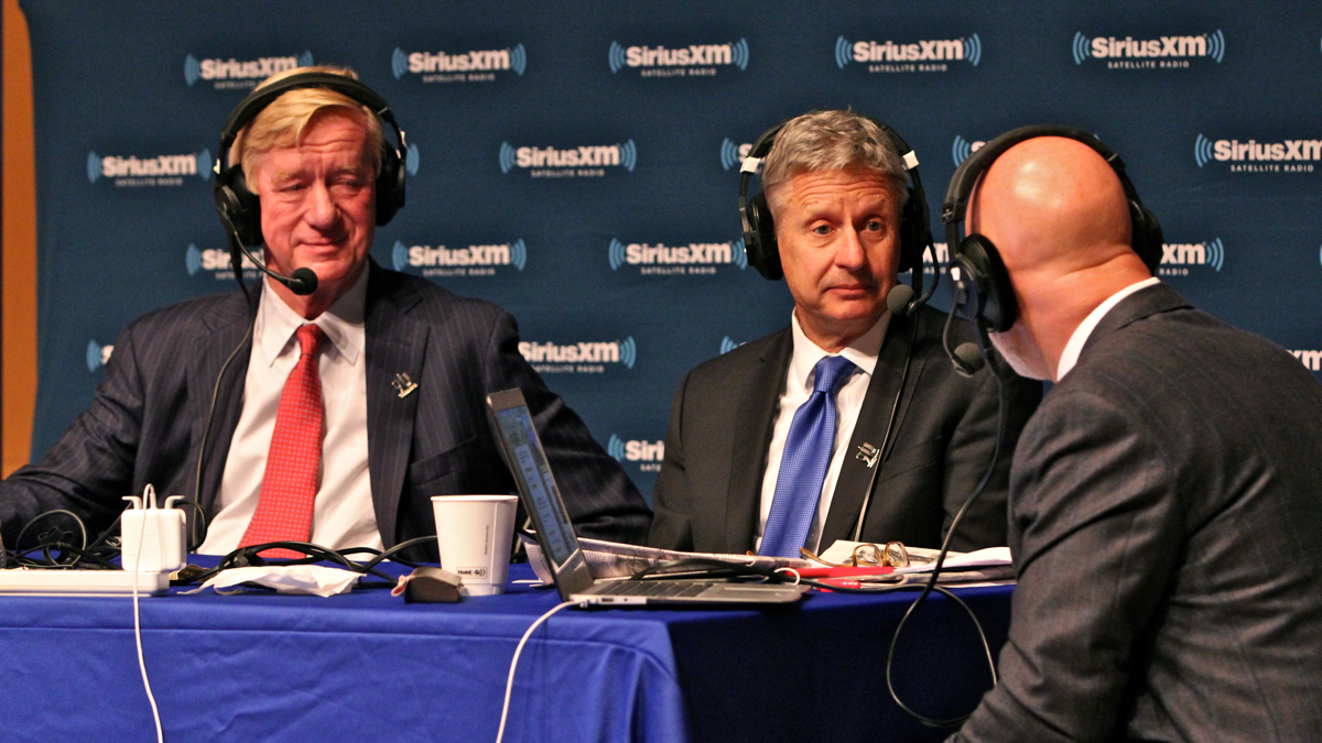 Libertarian presidential candidate Gary Johnson (center) and his running mate William Weld (left) speak with Sirius XM radio host Michael Smerconish during a forum at the National Constitution Center. (Emma Lee/WHYY)