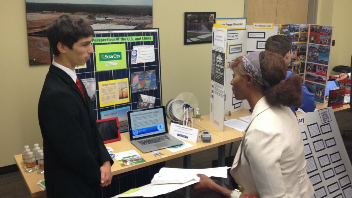  Sussex Tech student Trevor Roe (left) presents a project based on his time in China. (Avi Wolfman-Arent, NewsWorks/WHYY) 