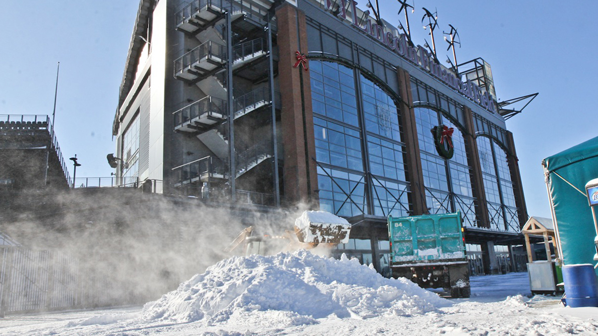 Crews work to remove about 10 inches of snow from Lincoln Financial Field Complex before Saturday's playoff game against the New Orleans Saints. (Kimberly Paynter/WHYY) 