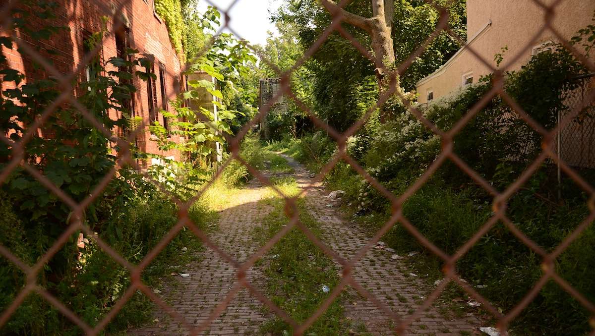  Vacant land behind the former site of the Queen Lane Apartments is part of the proposed play space area. (Jimmy Viola/for NewsWorks, file) 