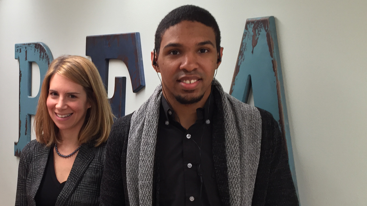 Irene Hurford and Oberon Wackwitz in front of a wall that reads 