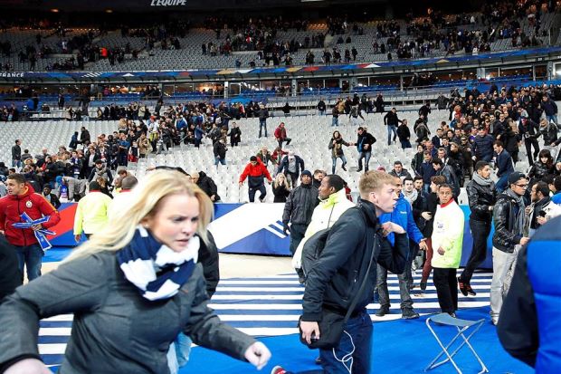  Spectators run from the Stade de France stadium Friday night after explosions were heard nearby. Several Millersville University students were in the crowd. (AP photo) 