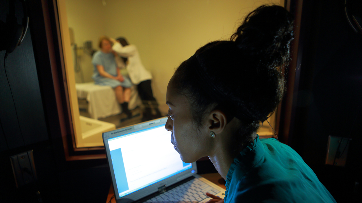 An instructor monitors interactions between 
