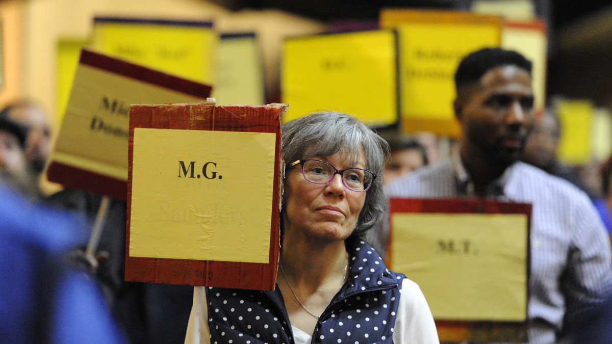  Bearing signs with the names and initials of those who died without a home in Philadelphia this year, activists  remember the departed Thursday in Arch Street United Methodist Church. They also called attention to the hundreds of young people with no home. (Jonathan Wilson/NewsWorks) 