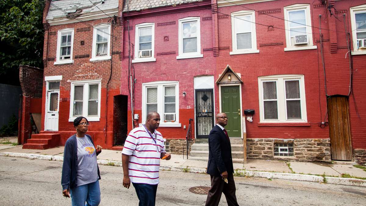  Principal William Wade (right) and MLK High conflict-resolution specialists Thomas Stubbs and Deborah Folk search for the home of an incoming freshman as part of their new mobile-orientation initiative. (Brad Larrison/for NewsWorks) 