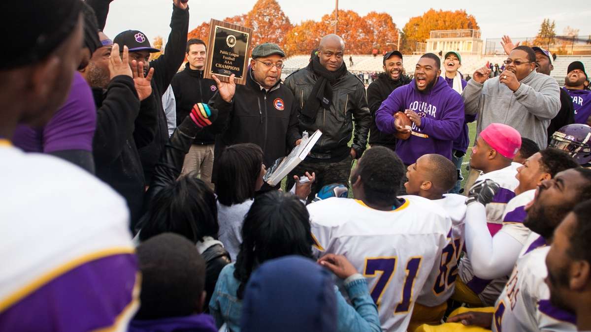  After winning the title game 32-7 on Saturday afternoon, the MLK High Cougars football players get their first look at the Public League AAA Championship plaque. Check back Monday for a recap of tomorrow's playoff game. (Brad Larrison/for NewsWorks) 