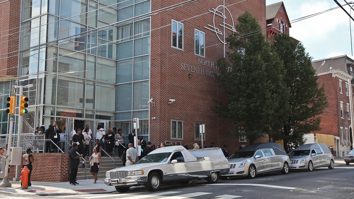  Mourners arrive at the Seventh-Day Adventist Church at 15th and Oxford streets in North Philadelphia on Monday morning for funeral services for the three children killed in a hit-and-run tragedy on July 25. (Kimberly Paynter/WHYY) 