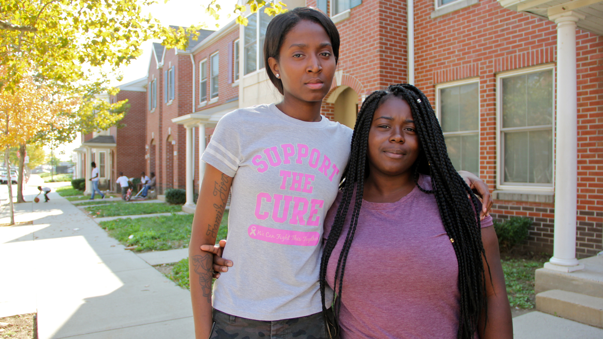  The sister and cousin of transgender murder victim Kiesha Jenkins, Ronnia Jenkins (left) and Sade Skelton, meet on Morris Avenue in South Philadelphia, where Jenkins lived. (Emma Lee/WHYY) 