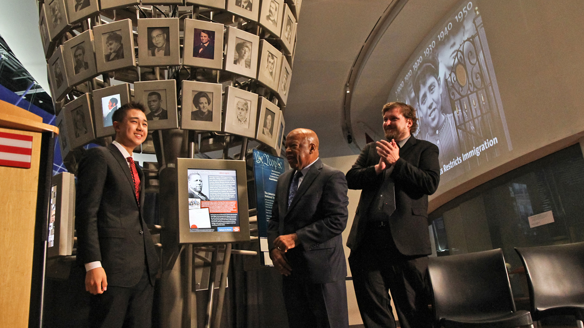  Congressman John Lewis and essay winner Sam Duffy unveil a new edition to the National Constitution Center's National Tree Exhibit, first African American Senator Hiram Rhodes Revels. (Kimberly Paynter/WHYY) 