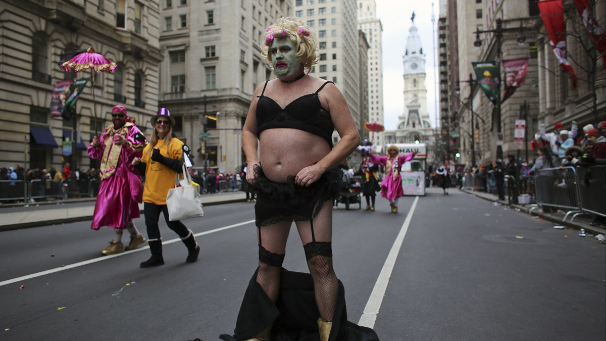  Comic club member Michael Kenney celebrates the New Year on South Broad Street and adjusts his costume during the 116th annual Mummers Parade in Philadelphia on Friday, Jan. 1, 2016. (AP Photo/Joseph Kaczmarek) 