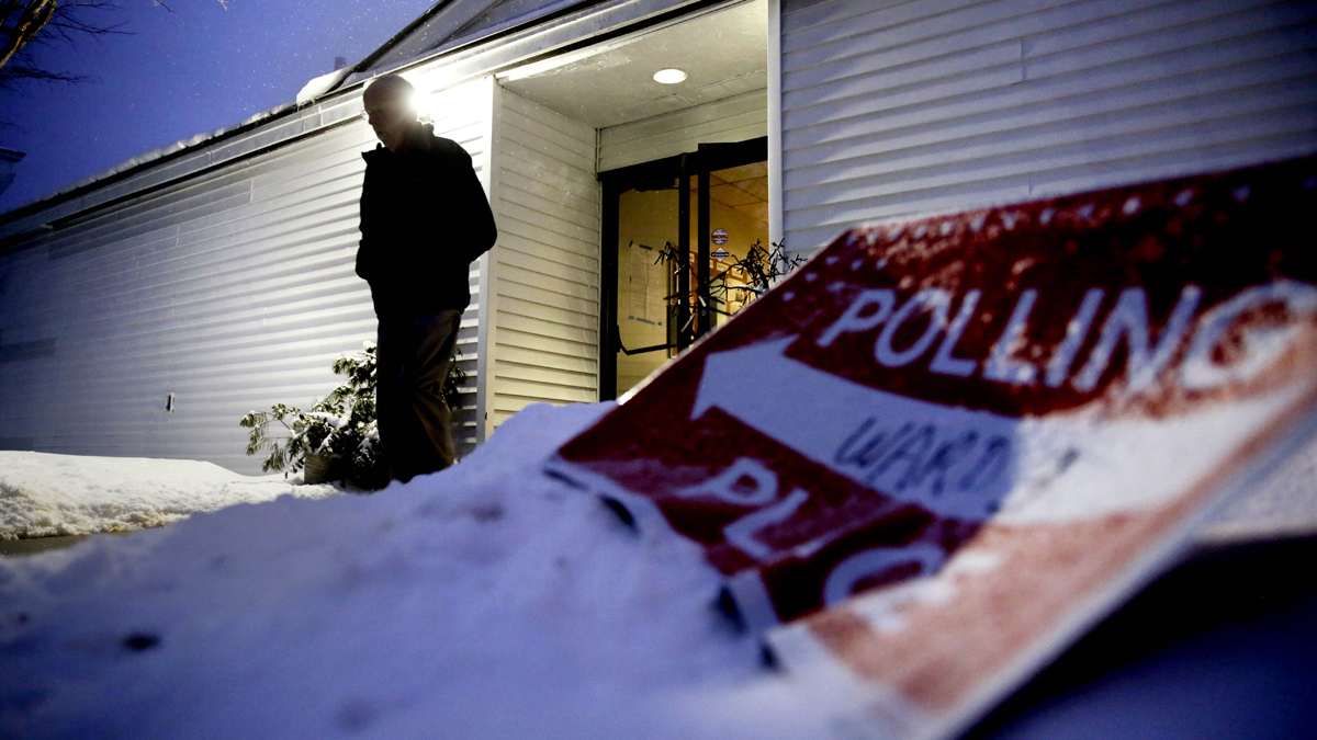 A voter leaves a polling site at dawn after casting a ballot. (AP Photo/David Goldman) 
