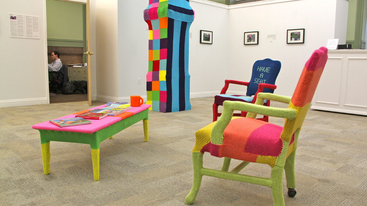  Michael Brown, a research and policy assistant for the Philadelphia arts and culture department works in his city hall office which was recently yarnbombed by artist Jessie Hemmons. (Emma Lee/WHYY) 
