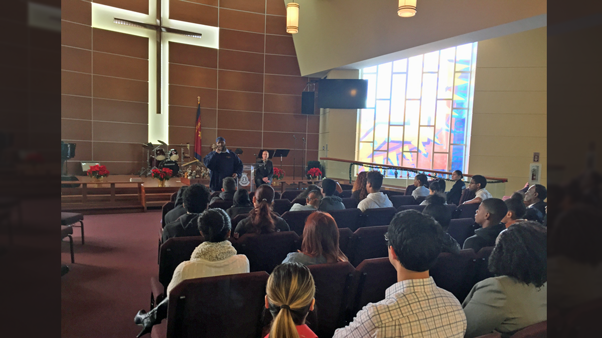 Former drug dealer and federal inmate Mark Lee talks to more than 20 at-risk youth and other community members during a Project Guardian event in Camden. (Joe Hernandez/WHYY)