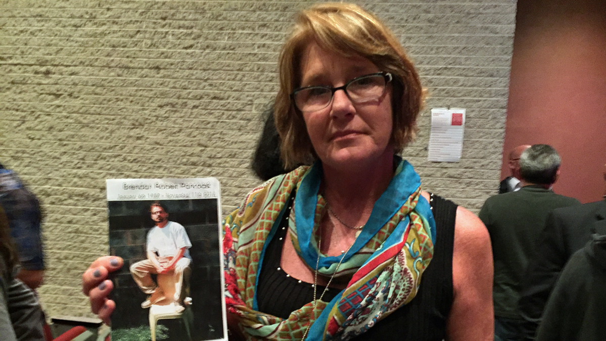  Margaret Pancoast holds a picture of her 25-year-old son, Brendan, who died last year after battling addiction for nearly half of his life. (Joe Hernandez/WHYY) 