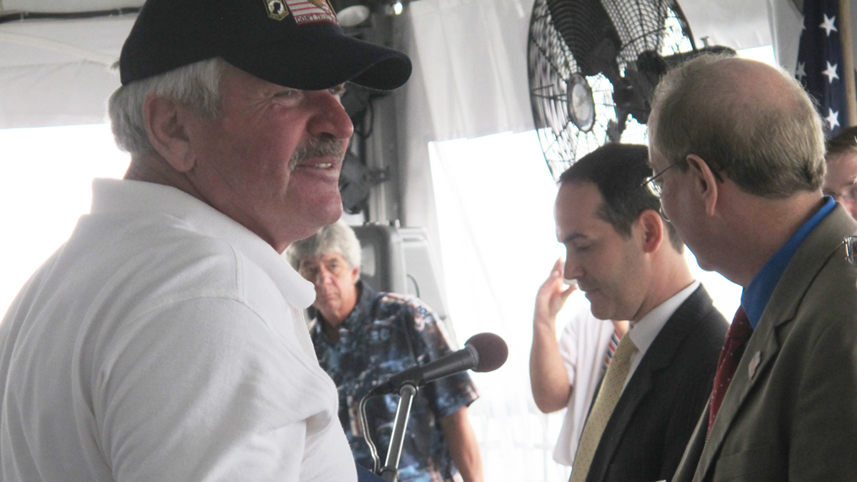  Victor Gryszkiewicz, 65, of South Toms River, receives his naturalization certificate from officials with U.S. Citizenship and Immigration Services in a ceremony on board the historic Battleship New Jersey in Camden. Gryszkiewicz is a Vietnam veteran who emigrated from Poland when he was just a year old. (Katie Colaneri/WHYY) 