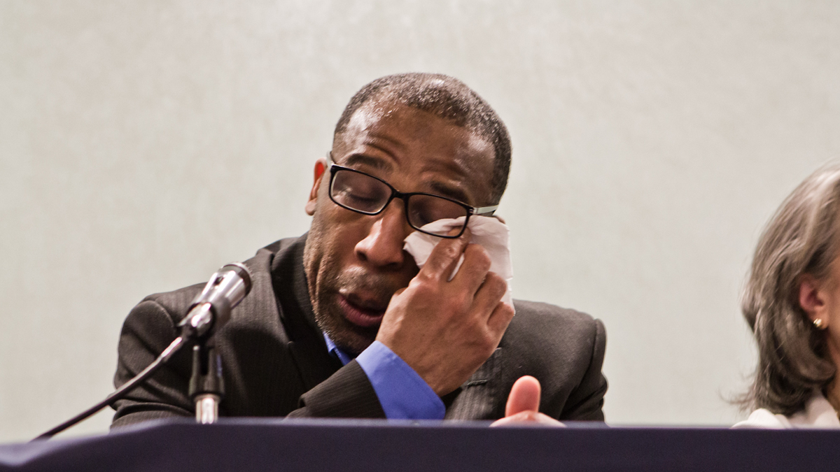 Anthony Wright, 45, was acquitted of a murder conviction, and release from prison after 25 years Tuesday. Wright wipes away tears during a press event  (Kimberly Paynter/WHYY)