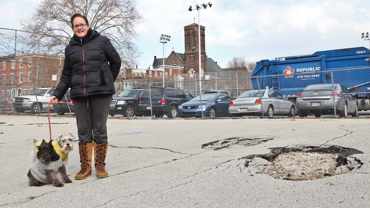  Ann Corcoran walks her miniature schnauzers Clooney and Baby Knute at the proposed site of a dog park in Philadelphia's Spring Garden District. (Kimberly Paynter/WHYY) 