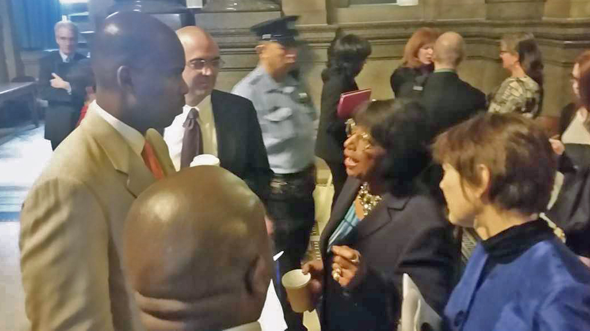  Derek Green talks to his mentor, Councilwoman Marian Tasco, in Council's Caucus room. (Tom MacDonald/WHYY) 