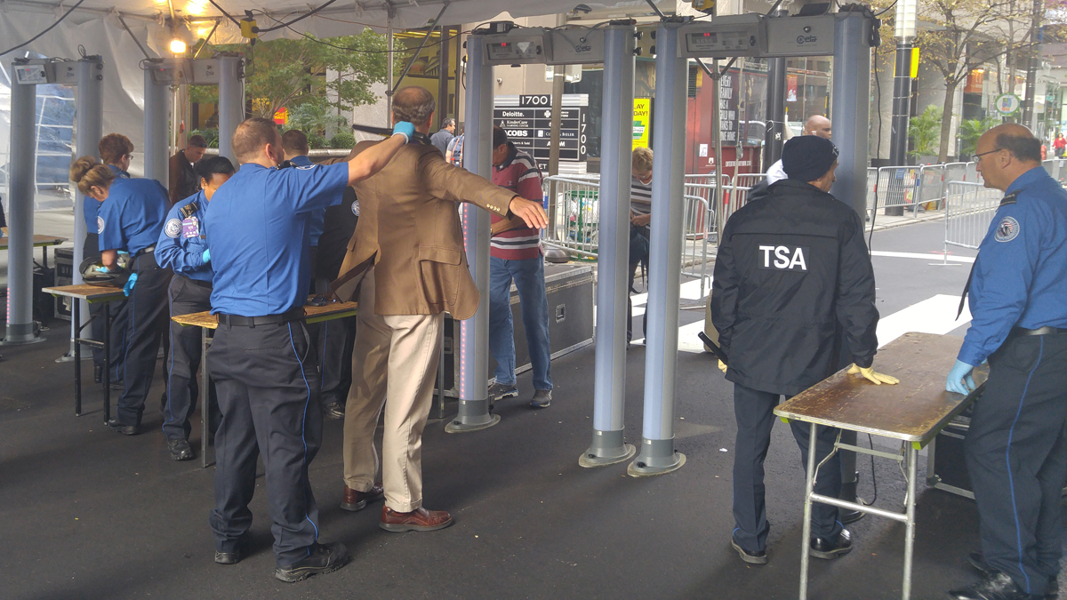  TSA agents wand people passing through metal detectors at 17th and Market Streets in Philadelphia (Tom MAcDonald/WHYY) 