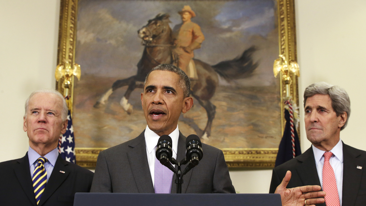  President Barack Obama, flanked by Vice President Joe Biden and Secretary of State John Kerry, gestures as he speaks about the Islamic State group, Wednesday, Feb. 11, 2015, in the Roosevelt Room of the White House in Washington. Obama asked the U.S. Congress on Wednesday to authorize military force to 