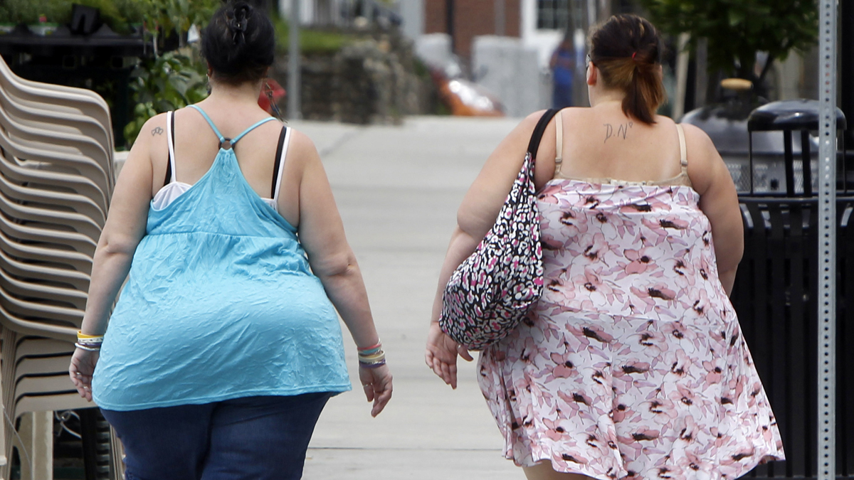 In this  June 17, 2013  photo, two women cross the street in Barre, Vt. In its biggest policy change on weight and health to date, the American Medical Association has recognized obesity as a disease. (AP Photo/Toby Talbot)