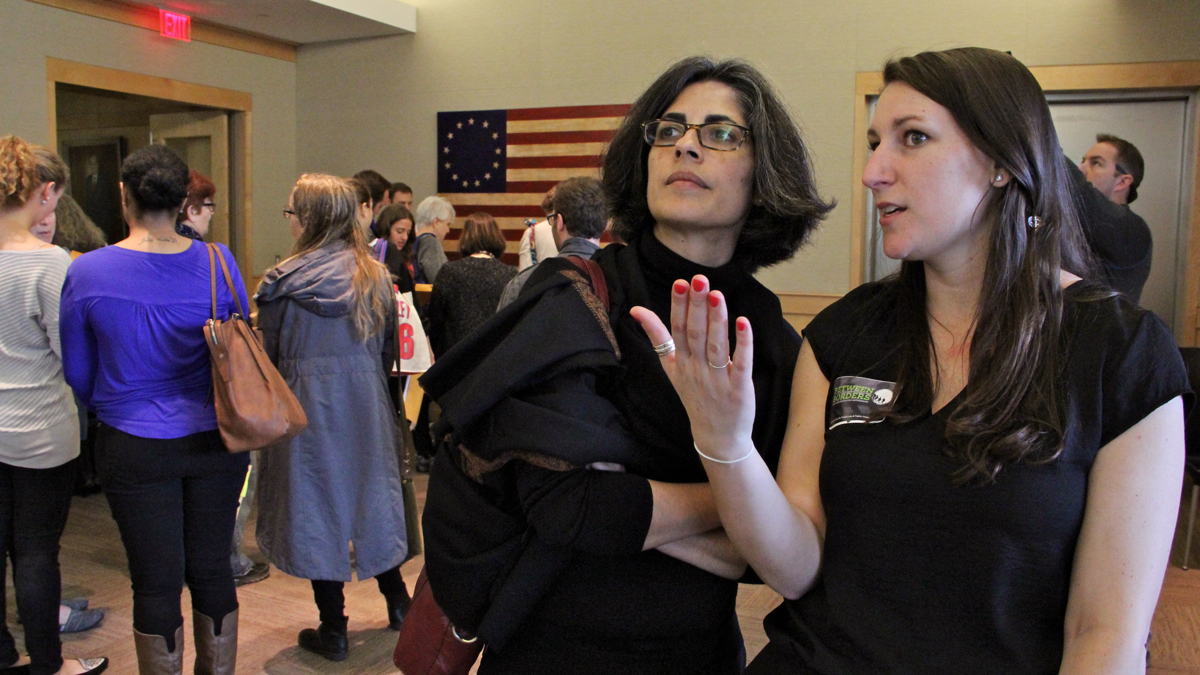 Temple law student Lilah Thompson, who organized 'Between Borders: A Refugee Simulation Experience' at the Naional Constitution Center, confers with her professor, Jaya Ramji-Nogales, co-director of the Institute for International Law and Public Policy. (Emma Lee/WHYY)