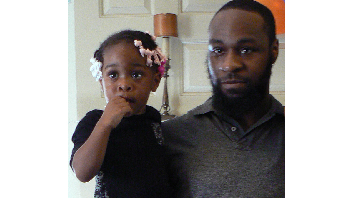Tyree Carroll holds his daughter (Carroll family photo)