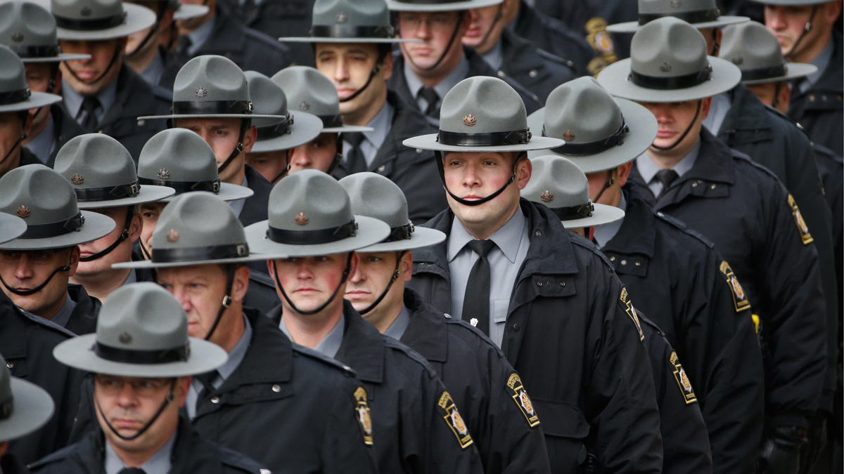  Officers salute as a hearse carrying the body of Jersey City Police Department Officer Melvin Santiago during a procession prior to funeral services. Santiago was shot in the head while still in his police vehicle July 13. His death has prompted some New Jersey lawmakers to call for reinstatement of the death penalty for police killers. (Julio Cortez/AP Photo) 