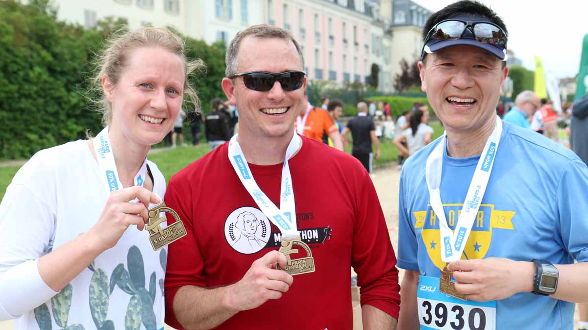  The Philadelphia Orchestra's principal tubist Carol Jantsch,  cellist Glenn Fischbach and concertmaster David Kim display their medals after running a half marathon in Paris. (Peter Crimmins/WHYY) 