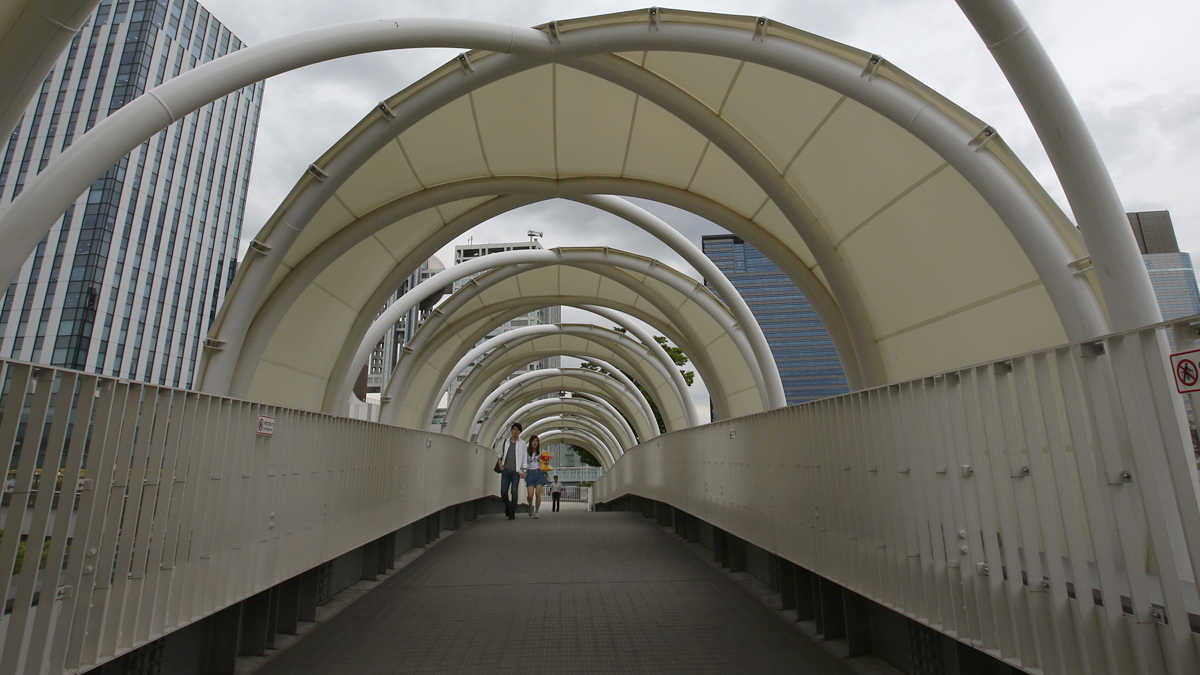  A couple walks through a bridge in Tokyo, Japan. Check out some of the wonders and potential dangers of bridges in the last section of this week's installment of ICYMI.  (AP Photo/Shizuo Kambayashi) 