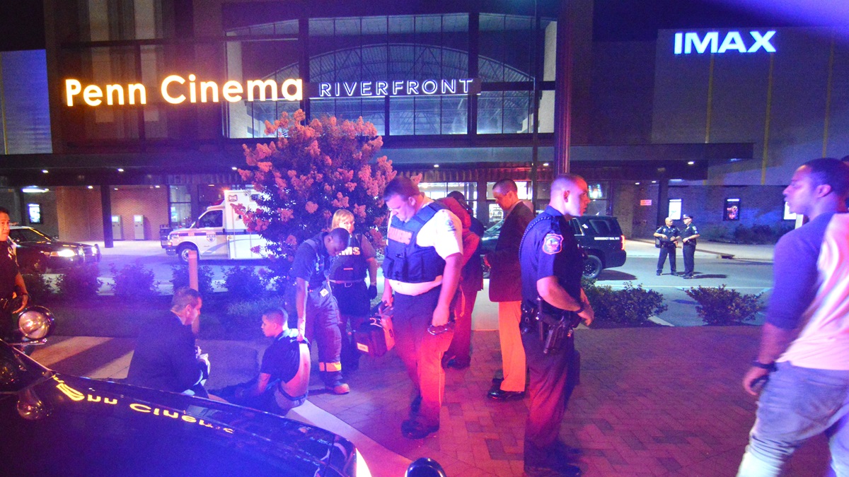  Police stand outside the Penn Cinema at the Wilmington Riverfront after a shooting victim was found in theater parking lot. (John Jankowski/for NewsWorks) 