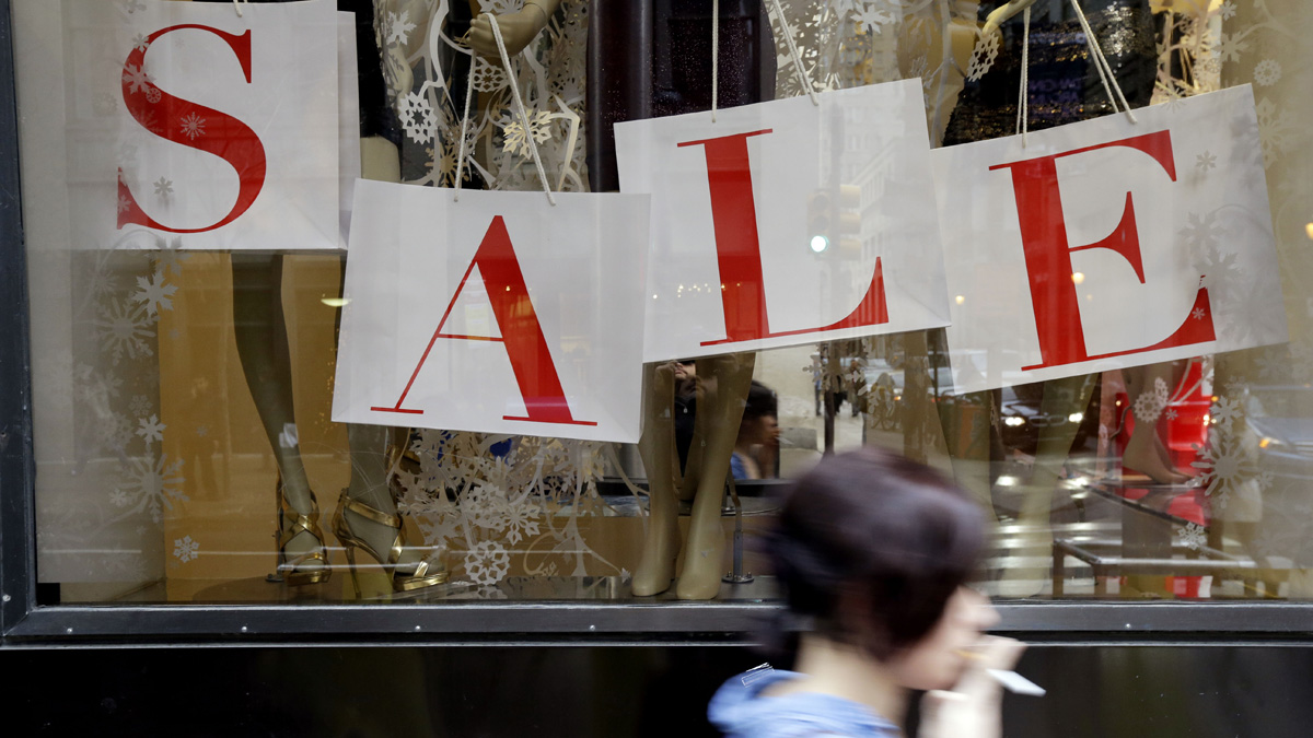  A person passes a retail store with sale sign displayed in the window in Philadelphia. (AP Photo/Matt Rourke, file) 