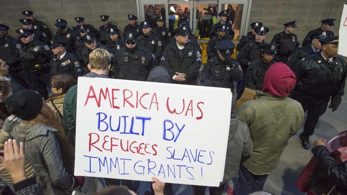 Police prevent protesters from entering the terminal at Philadelphia International Airport. (Branden Eastwood for NewsWorks)